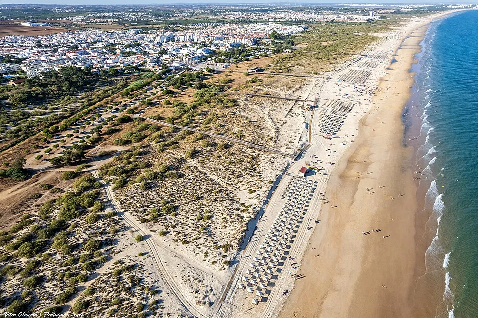 Beachfront residential buildings overlooking the sandy coastline at Praia da Manta Rota