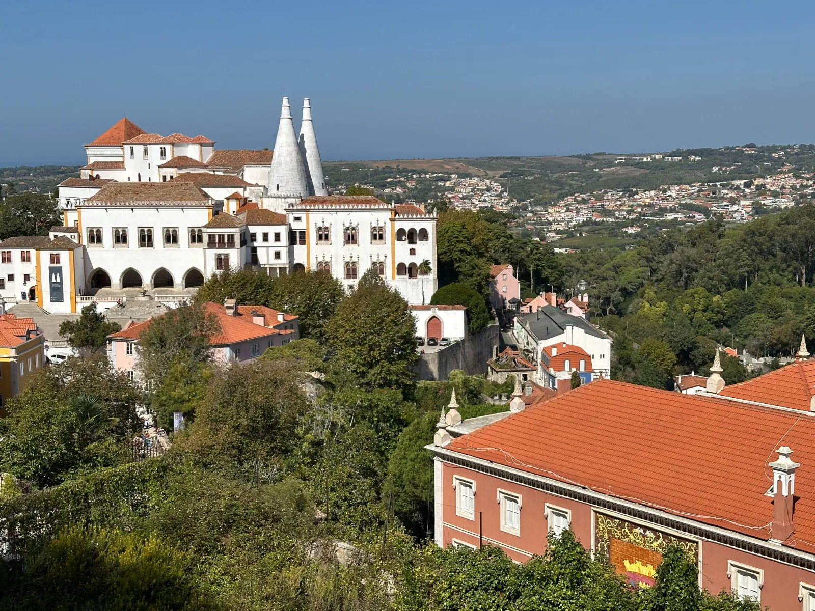 Main square of Sintra's old town with the National Palace chimneys behind
