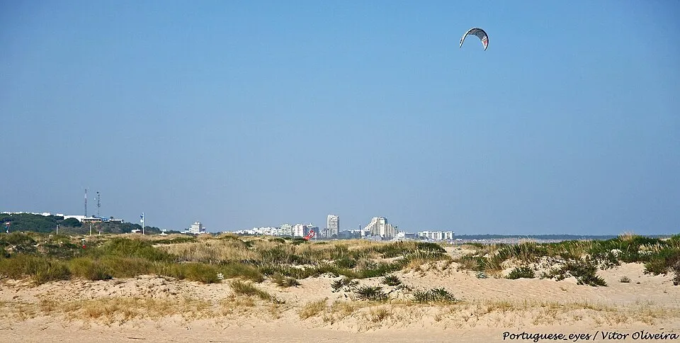 Wide sandy shoreline and modern residential villas near Praia da Lota in Manta Rota