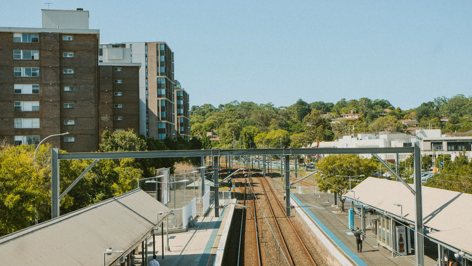 Apartment blocks beside a commuter railway platform